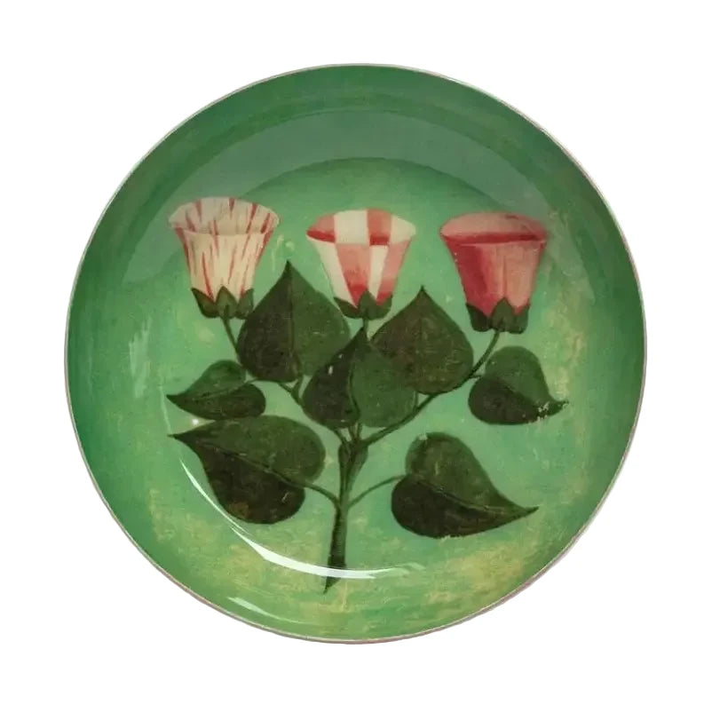 Round green enamel tray with illustrated pink flowers and leafy stems.