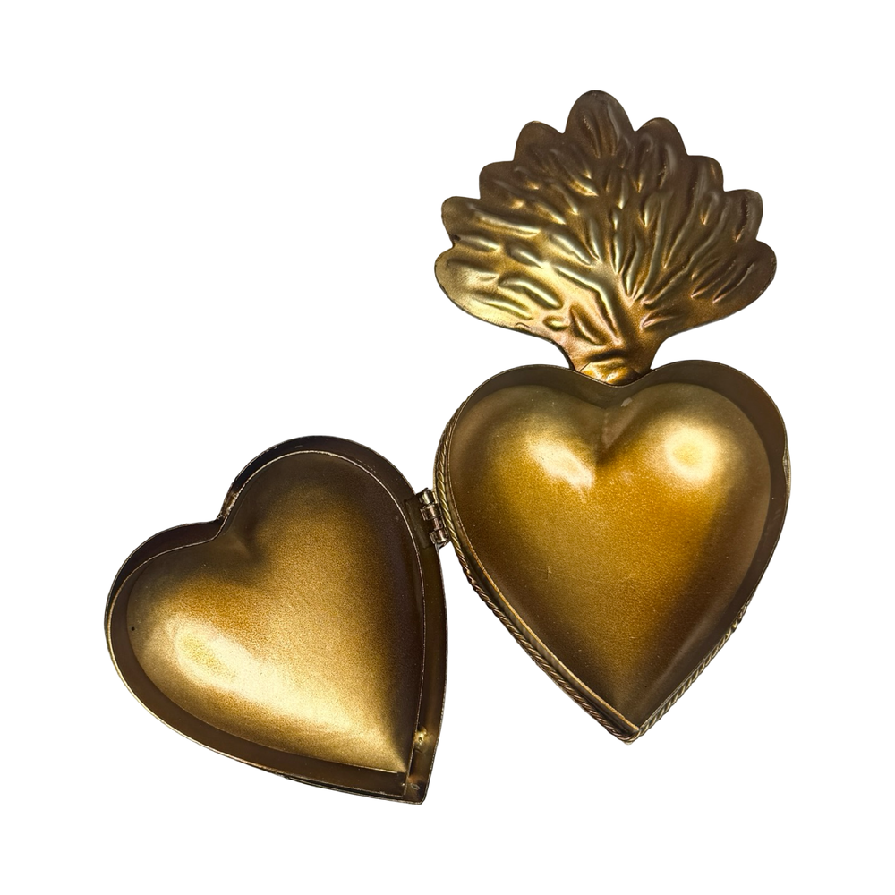 opened brass heart locket featuring an engraved design.