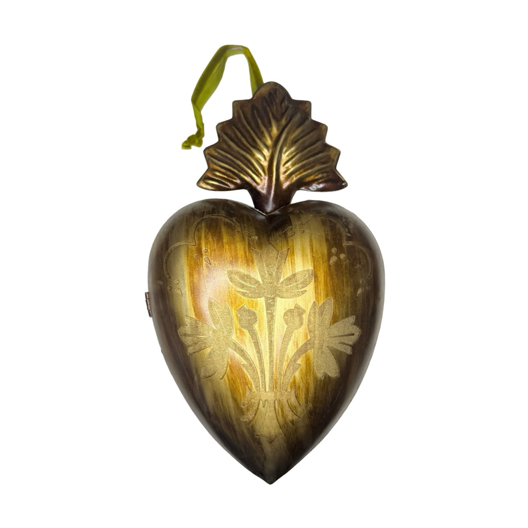 brass heart locket featuring an engraved design with a green velvet hanging loop