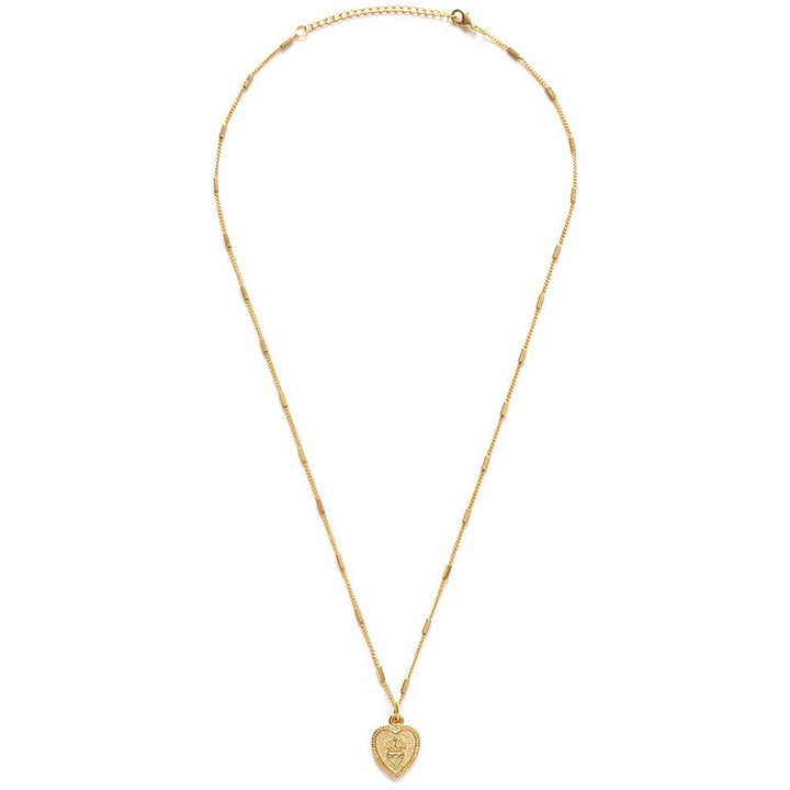 gold heart shaped pendant necklace featuring a sacred heart. Brand: Amano Studio