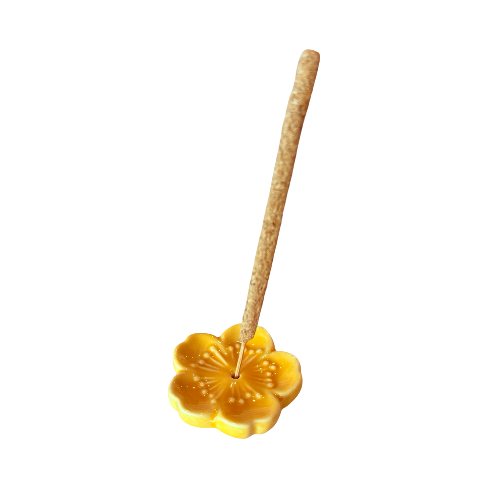 Golden yellow  cherry blossom incense holder with an incense stick.