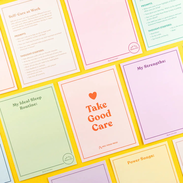 A collection of pastel-colored self-care worksheets with prompts and thought-starters laid out on a vibrant yellow background. The sheets feature various wellness topics like "My Ideal Sleep Routine," "My Strengths," and "Take Good Care."
