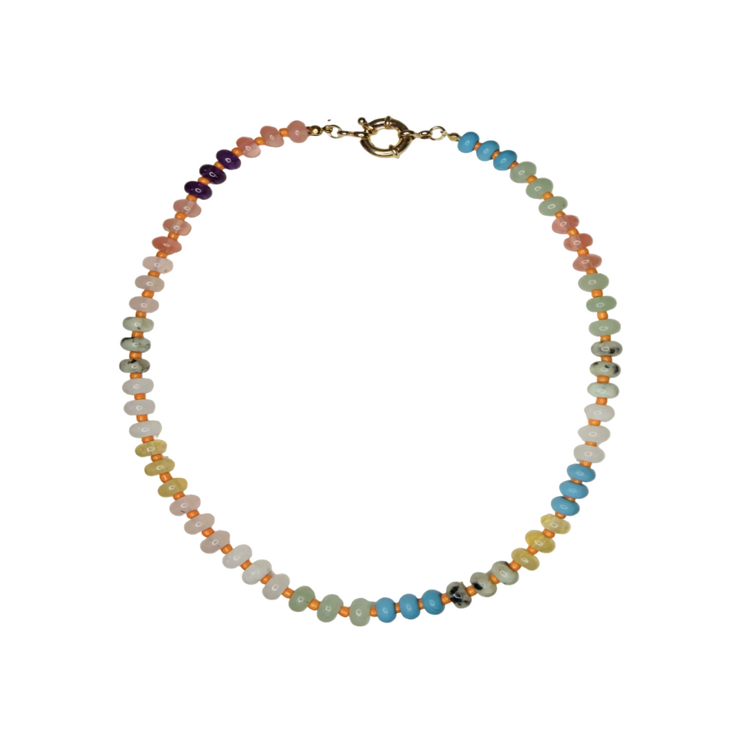 A semi-precious stone bead necklace with mixed pastel tones including turquoise, sage green, blush pink, purple, and yellow beads separated by small orange seed beads, with a gold spring ring clasp.