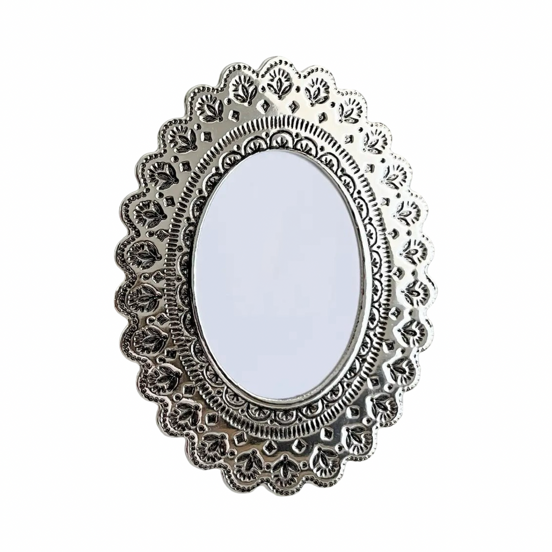 Faux tin oval frame in silver with embossed floral details.
