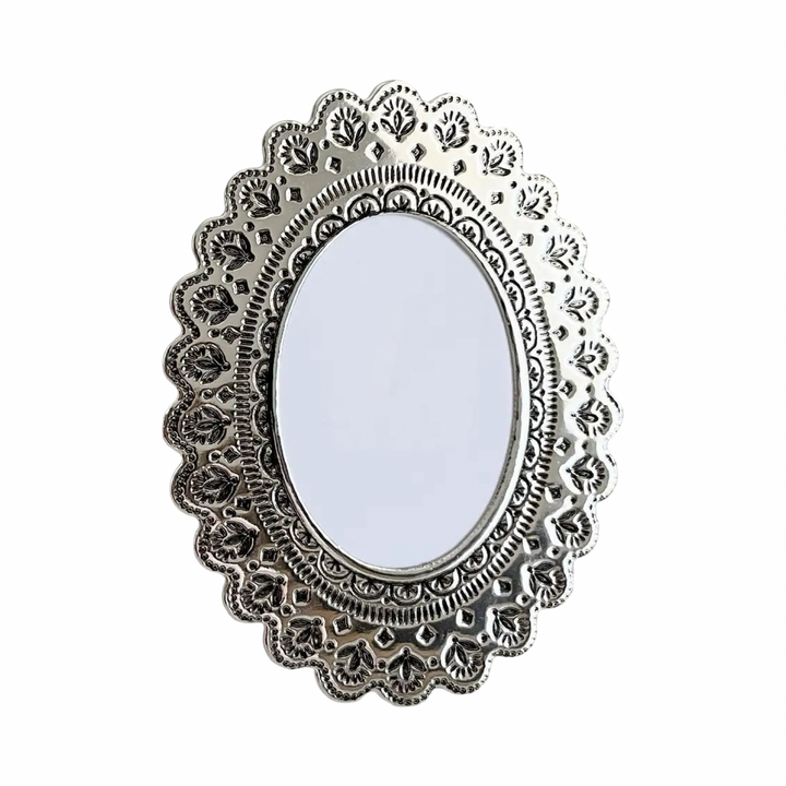 Faux tin oval frame in silver with embossed floral details.