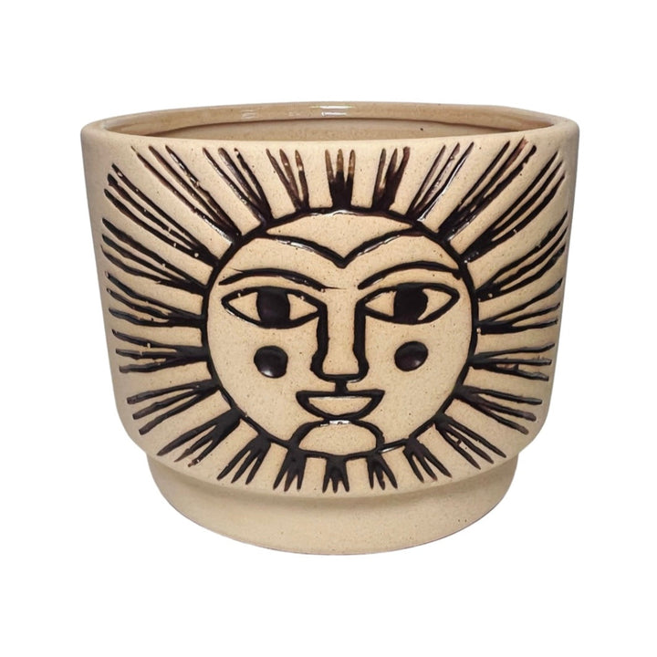 Beige ceramic cachepot with with an engraved design of a sun filled in with dark brown.