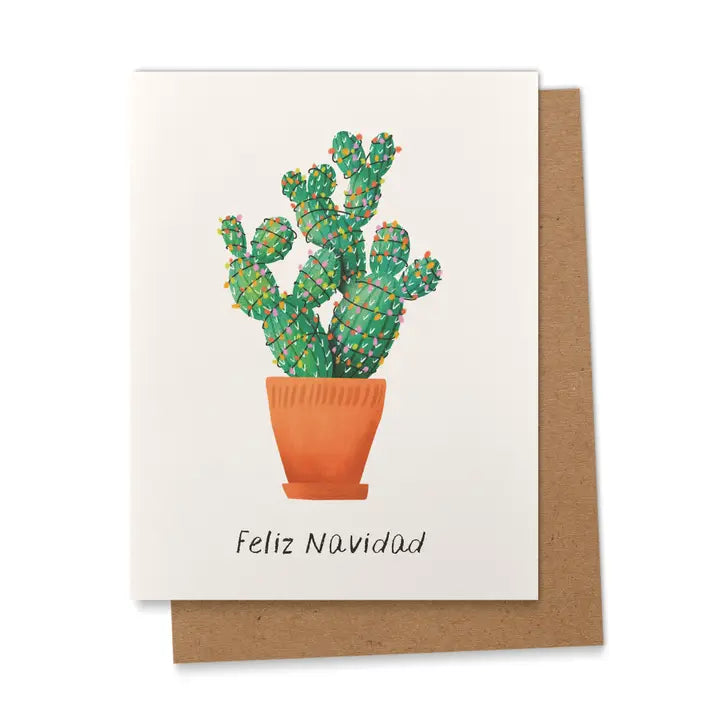 Greeting card with a green cactus decorated with colorful Christmas lights in a terracotta pot, with the words “Feliz Navidad” in black letters.