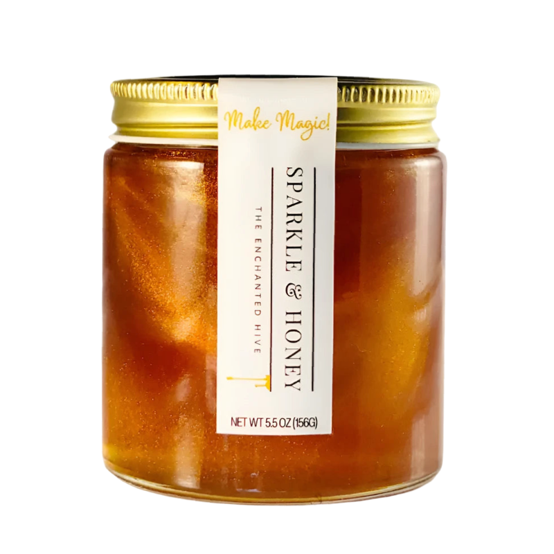 5.5 oz clear  jar of  golden honey mixed with edible glitter has a gold lid and white label.