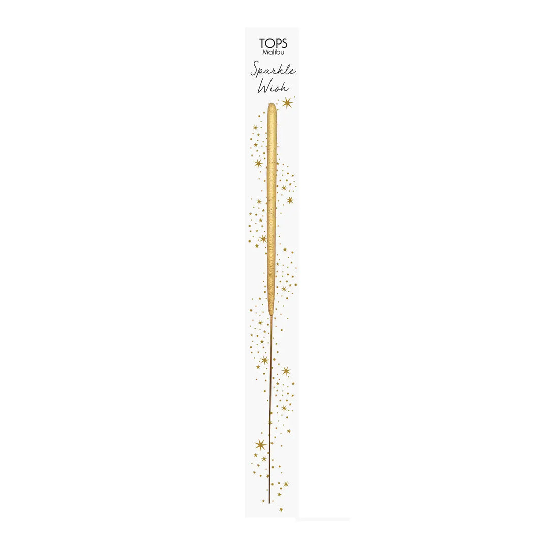Gold wand-shaped sparkler on a white branded card decorated with golden stars.