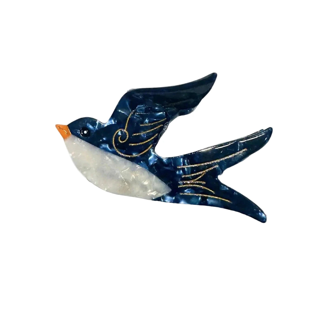 Hand-painted swallow-shaped hair clip with a marbled blue finish, gold detailing, and an orange beak.