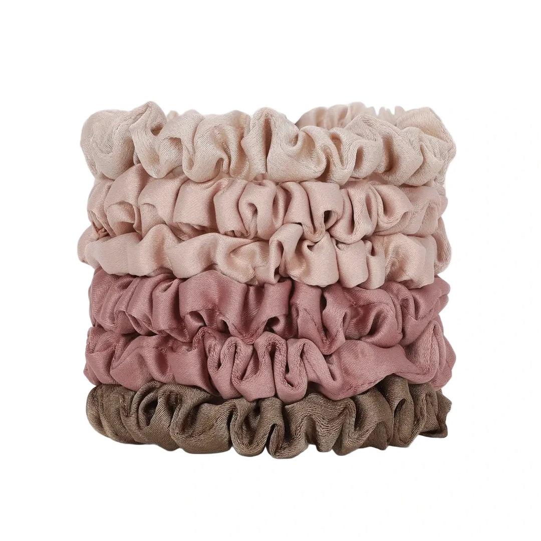 Stack of six ultra petite satin scrunchies in terracotta-inspired shades ranging from light beige to deep brown.
