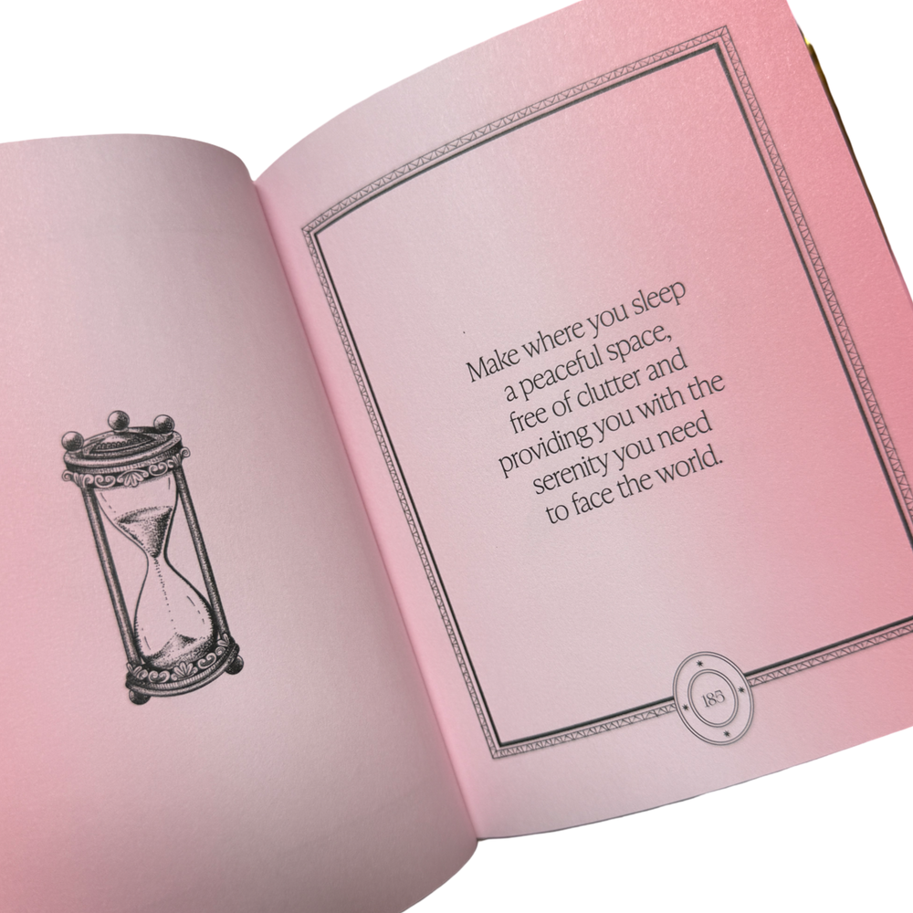 Open book with pink pages featuring a quote and an hourglass illustration on a white background