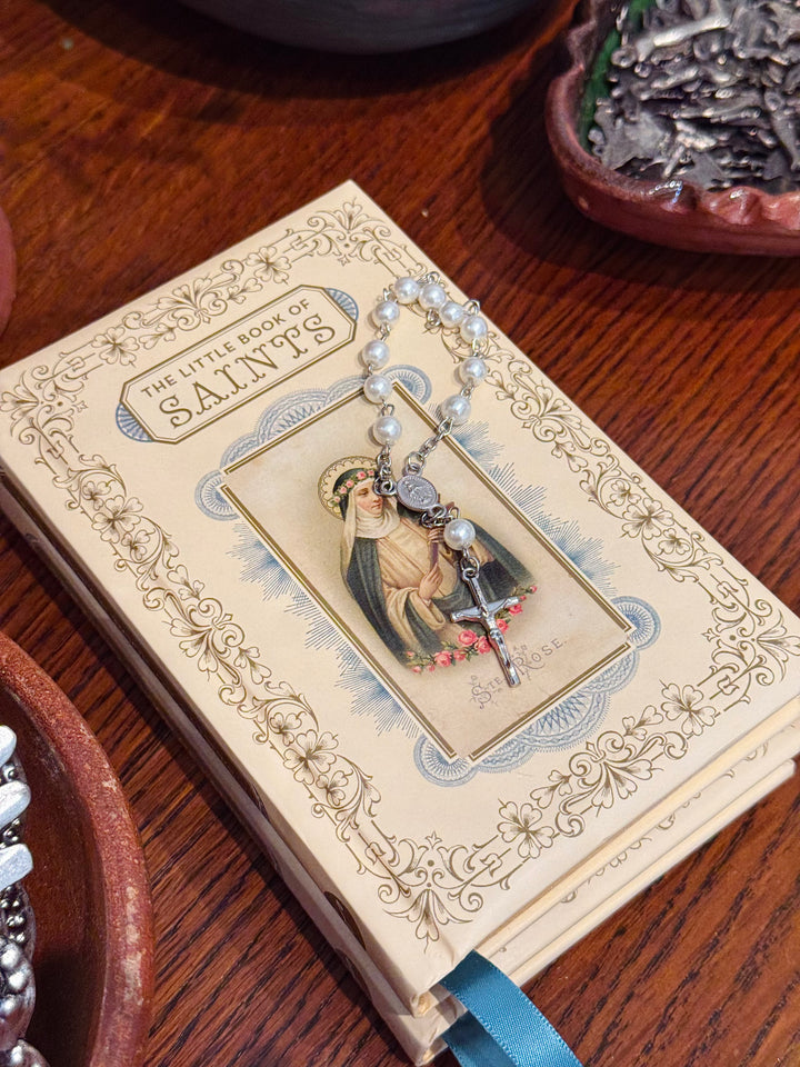 Decorative book with a religious pendant on a wooden surface