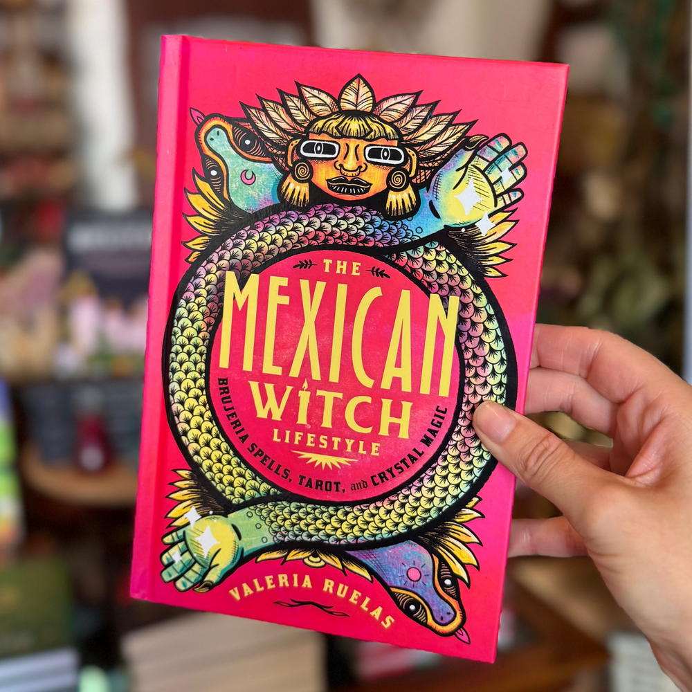 The red cover of the book 'The Mexican Witch Lifestyle: Brujeria Spells, Tarot, and Crystal Magic' features vibrant, colorful artwork with a stylized illustration of a witch and a snake, symbolizing the book's theme of Mexican brujería spirituality.
