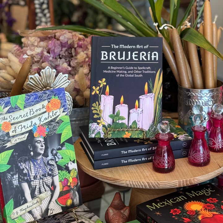 Books on a table with decorative items in a cozy room setting
