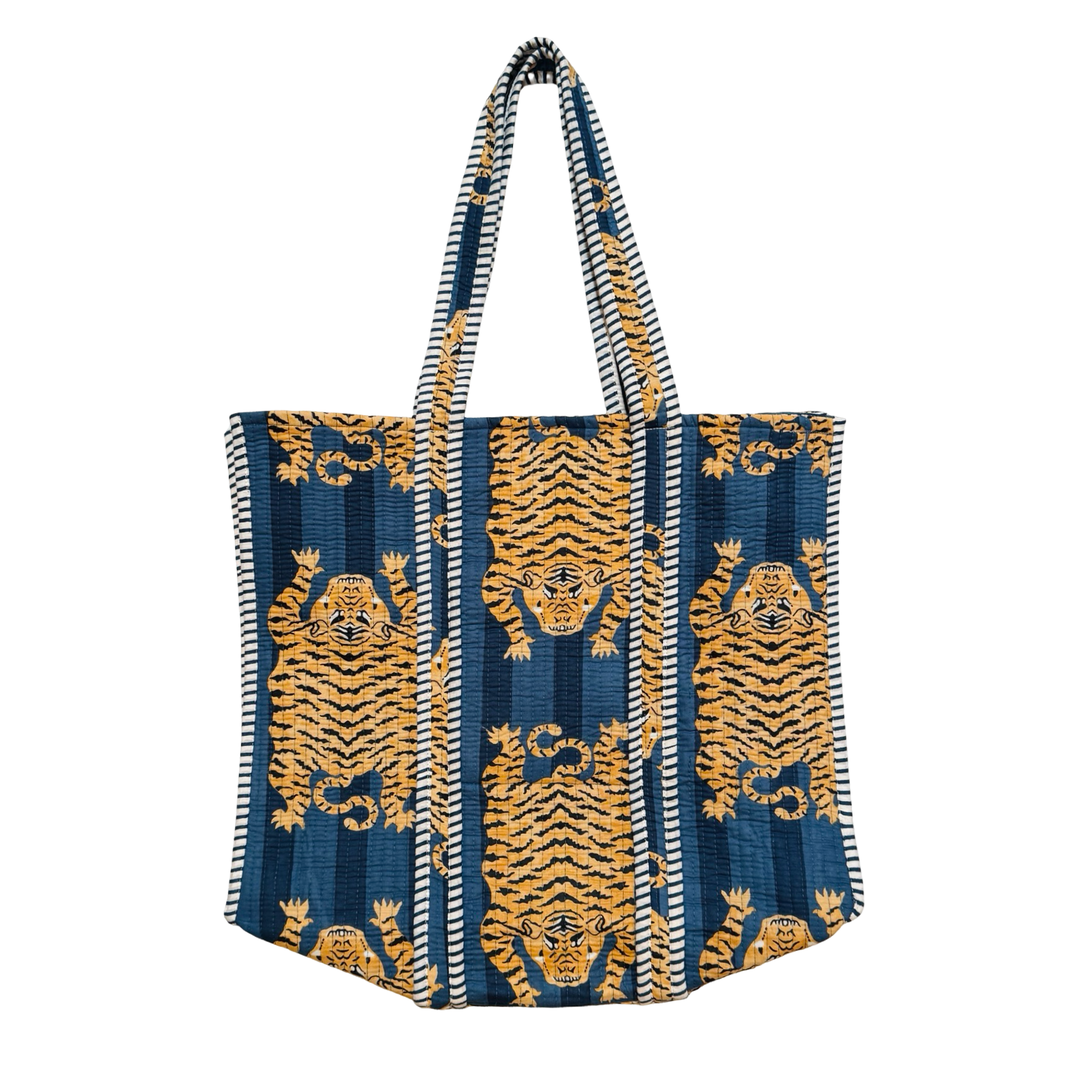 quilted tote bag with a blue and grey striped background featuring a repeated tiger pattern.