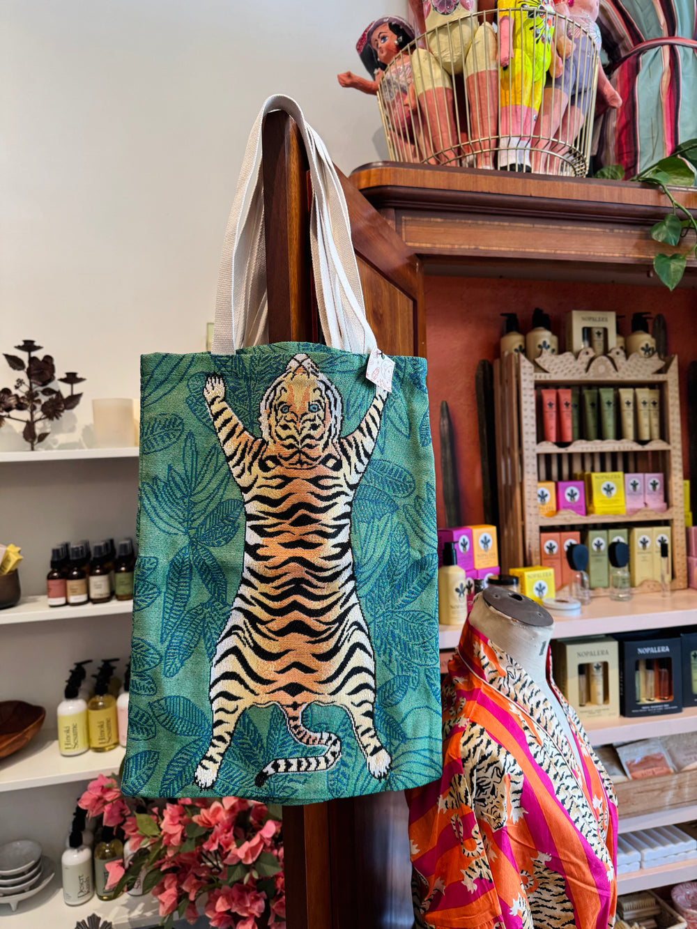 Tote bag with tiger design in a store setting