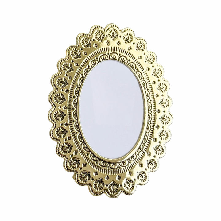 Faux tin oval frame in gold with embossed floral details.