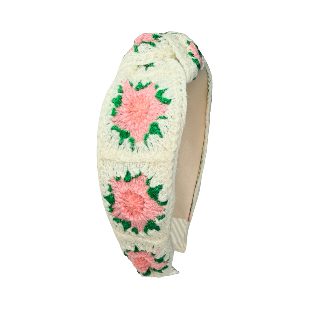 Cream crochet headband with pink and coral floral patterns and a knotted top design.