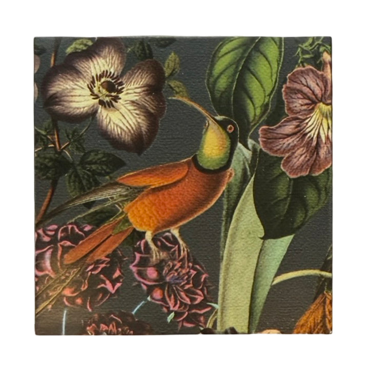 Dark green square matchbook featuring a single orange hummingbird perched on a branch surrounded by purple, green and pink flowers.
