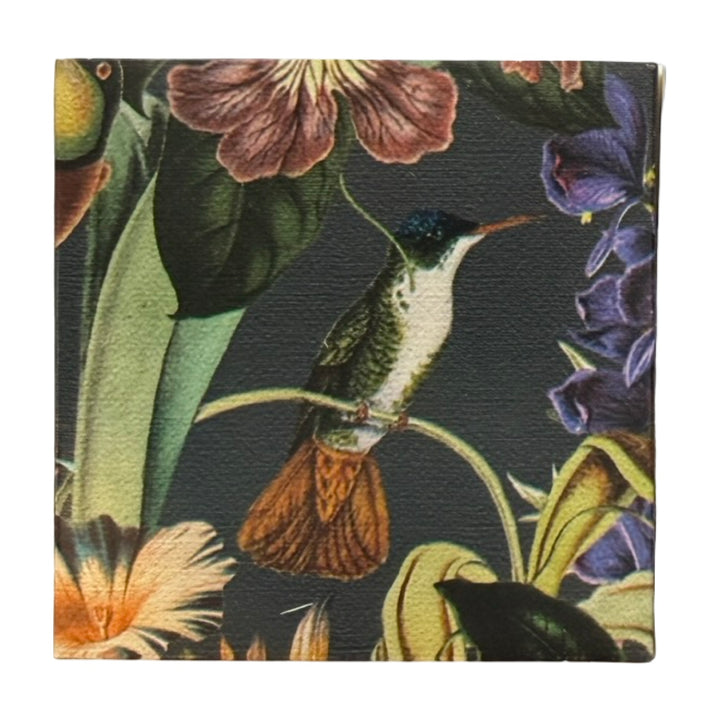 Dark green square matchbook featuring a single green and white hummingbird with an orange tail perched on a branch surrounded by purple, green and pink flowers.