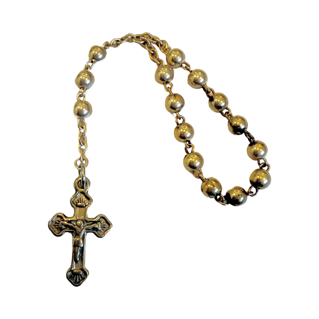Stainless steel rosary-style keepsake with polished beads and a detailed crucifix on a short chain.
