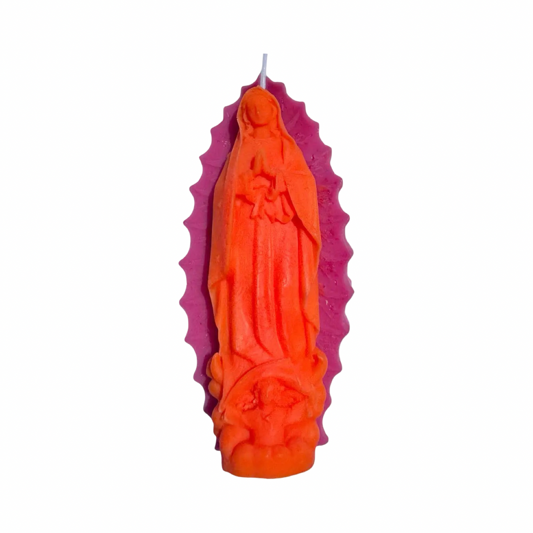 Bright pink and orange embossed Virgen de Guadalupe figural candle with detailed relief and decorative halo.