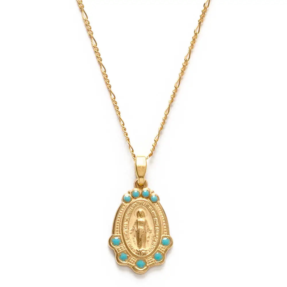 Close up view of a Virgin Mary Medallion with turquoise accents on a gold chain.
