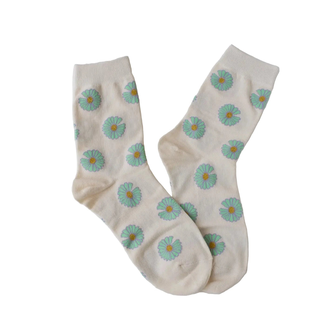 Pair of cream women’s socks patterned with mint-green daisies and yellow centers.