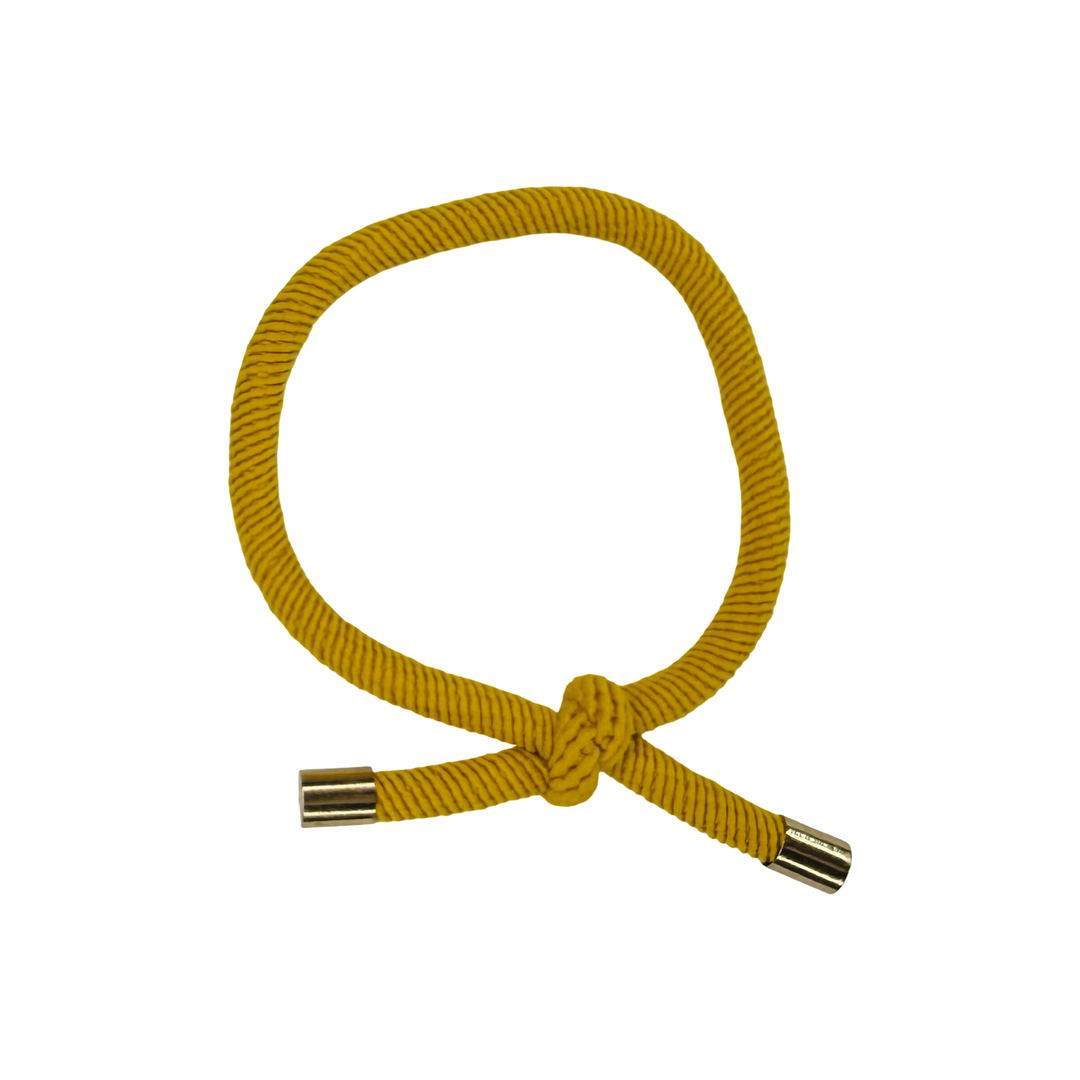 Yellow elastic hair cord with knot closure has metal grommet end caps.