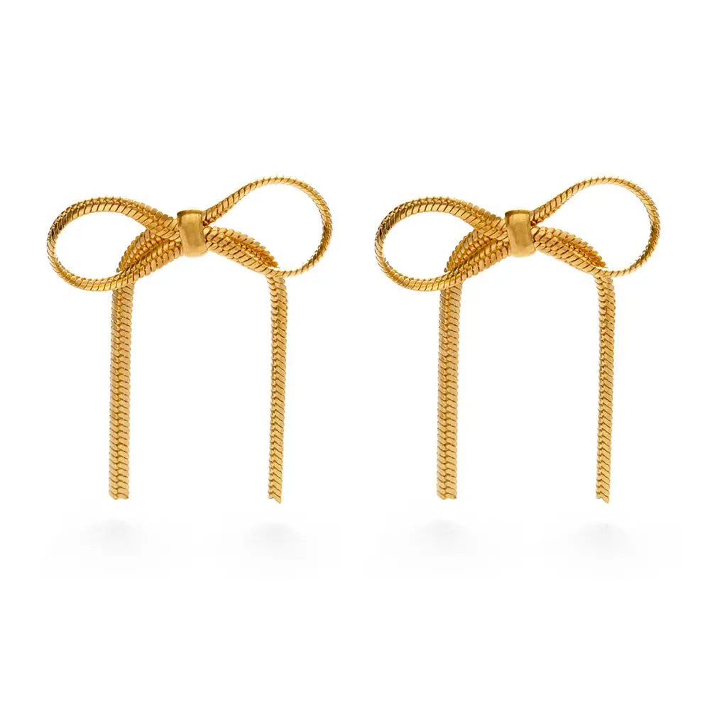 A pair of gold herringbone chain bow stud earrings featuring delicate loops and flowing chain tails, displayed against a white background.