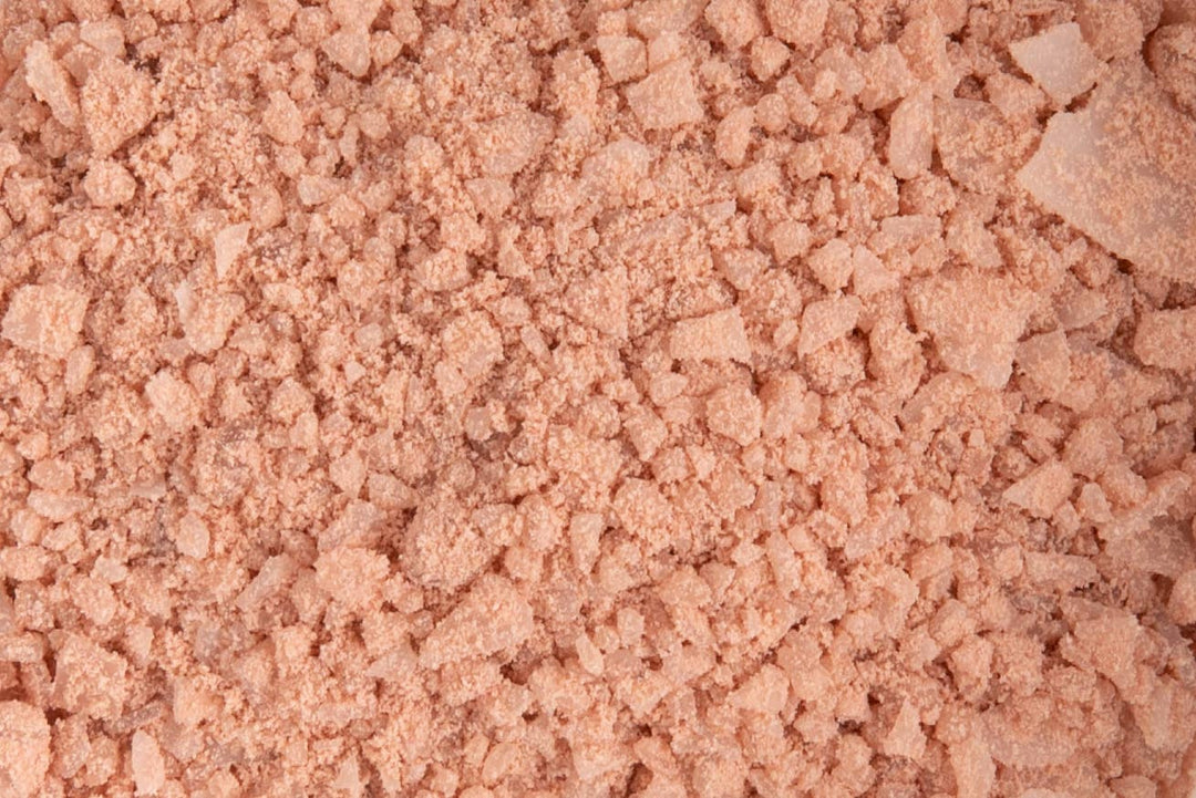 close up view of coral colored bath salt