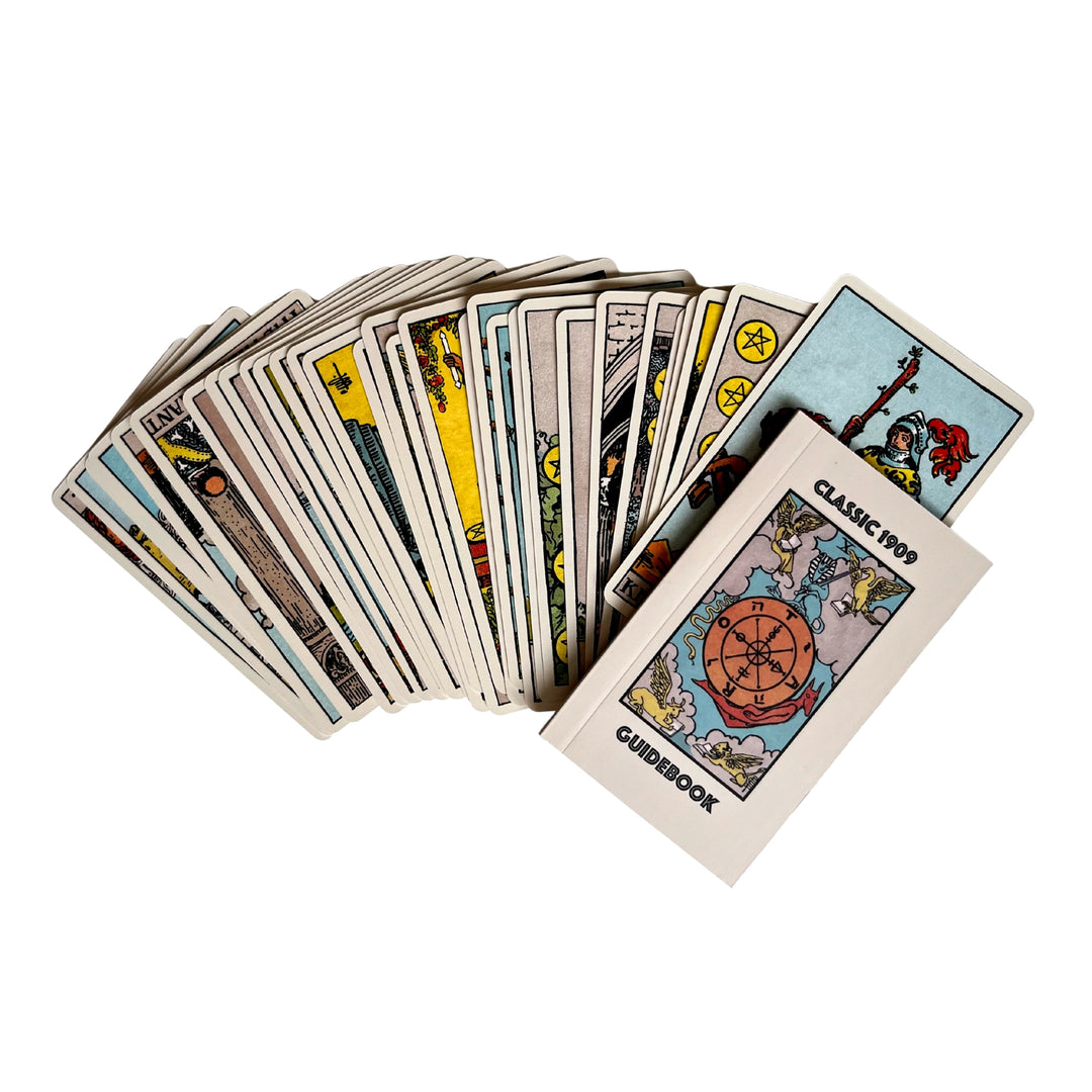Spread of Classic 1909 tarot cards with a small guidebook placed on top.
