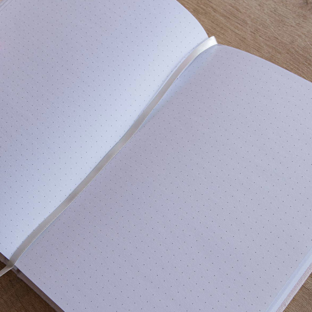 white page of a journal with a dot grid