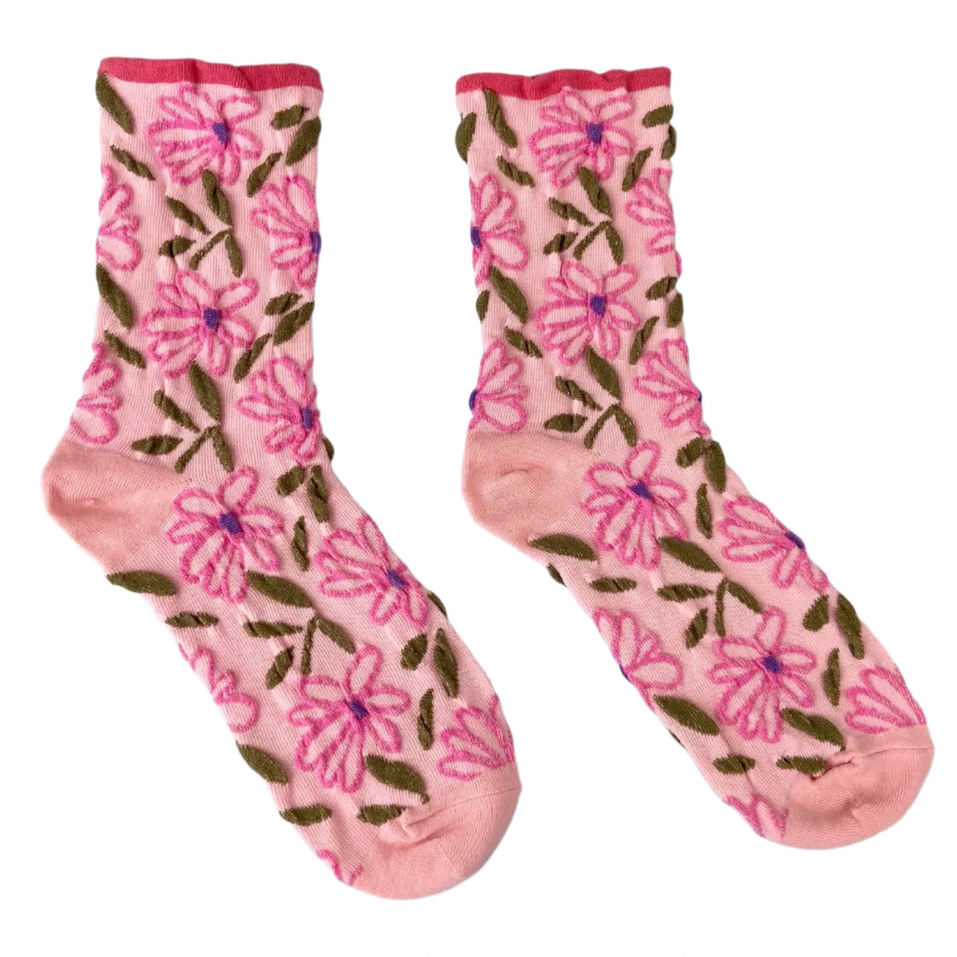 A pair of pink tube socks adorned with vibrant pink flowers and green leaves, set against a white background.