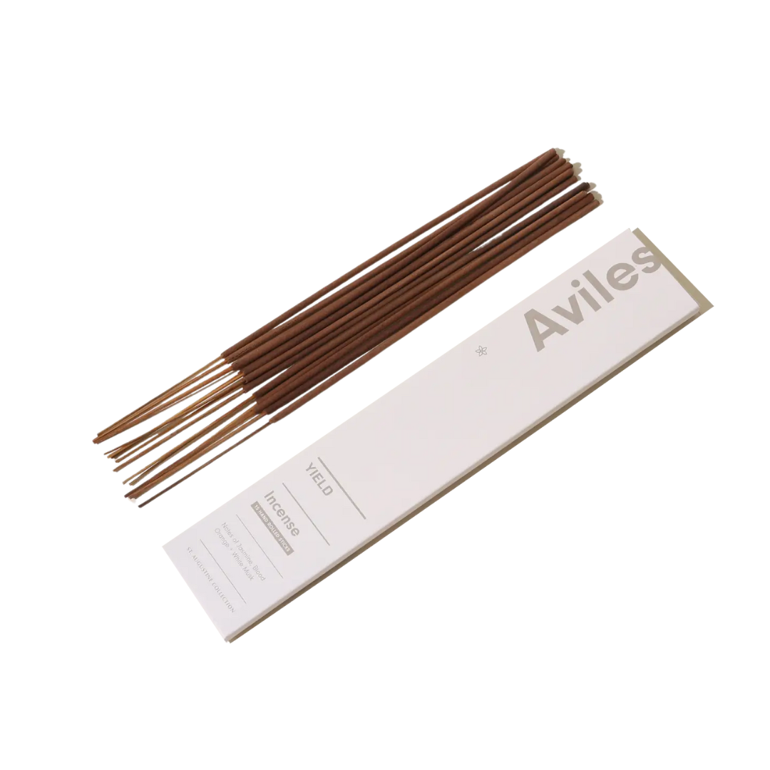 photo of brown incense sticks alongside branded packaging