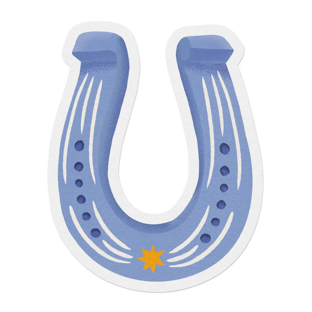 A die cut sticker shaped like a blue horseshoe with white stripe detailing, nail hole dots, and a small gold star at the center bottom.