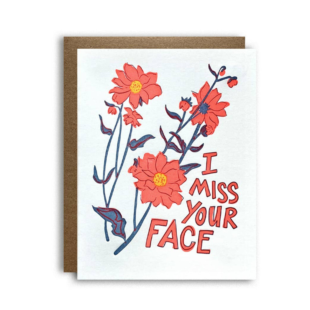white card with a brown envelope featuring orange flowers and the phrase I Miss Your Face in orange lettering