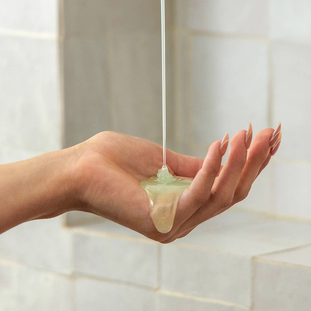cactus shower gel pouring onto a woman's hand. Brand: Nopalera