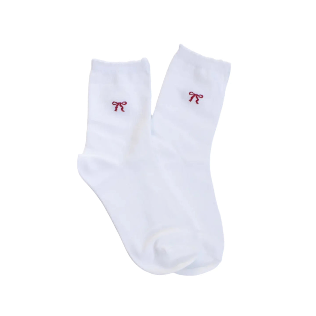pair of white socks with a small delicate red bow on the top