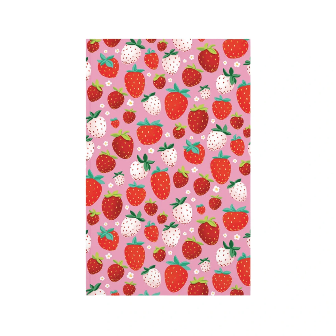 A pink journal cover featuring a playful pattern of red and white strawberries, green leaves, and small white flowers, creating a fresh and vibrant design.