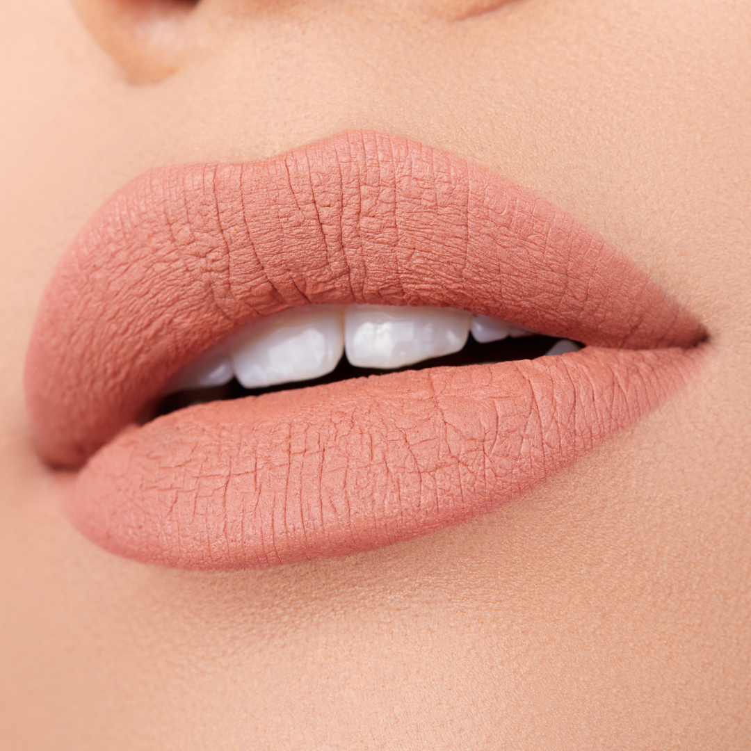 close up of a pair of lips with nude lipstick. Brand: Araceli Beauty