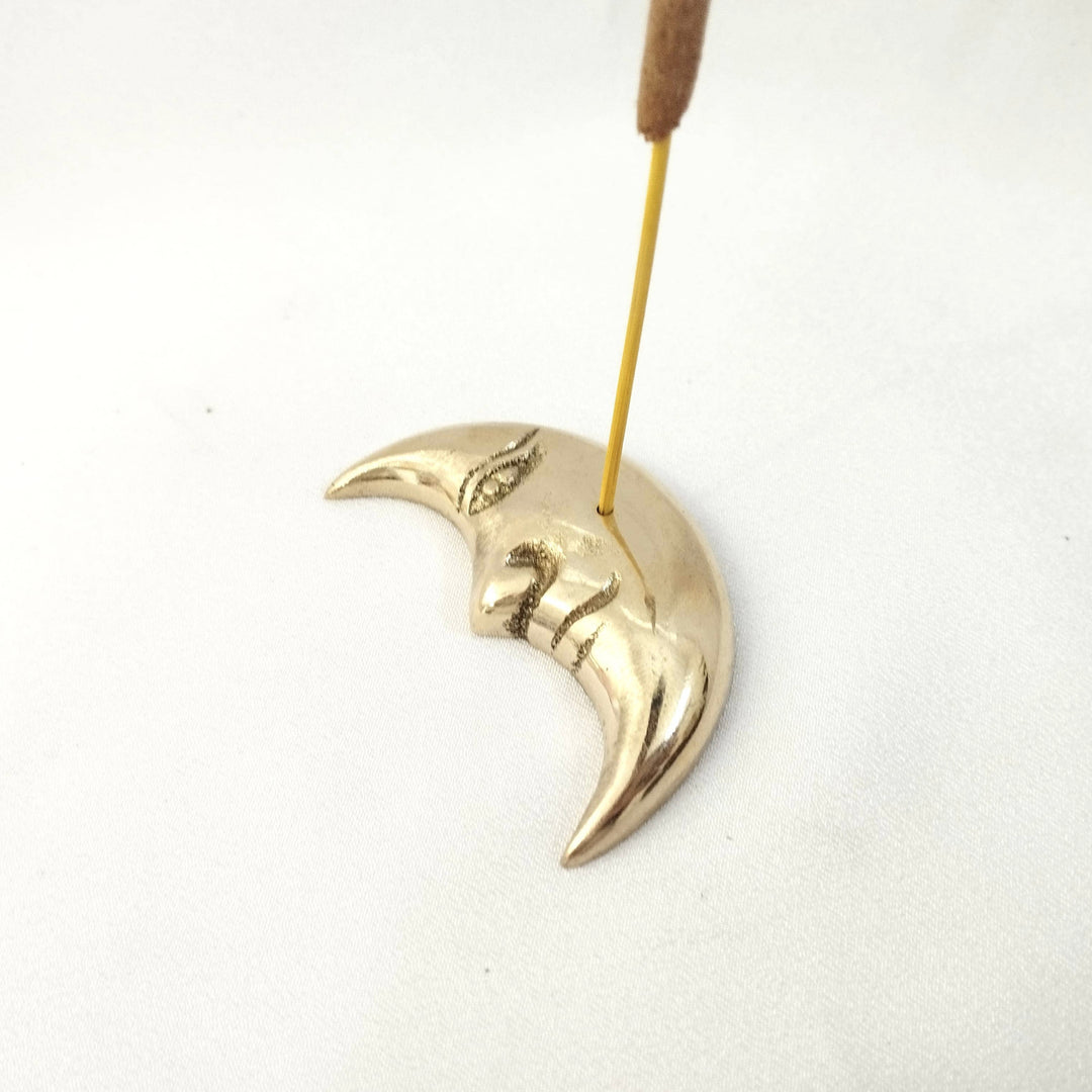 brass moon incense stick holder with an incense stick