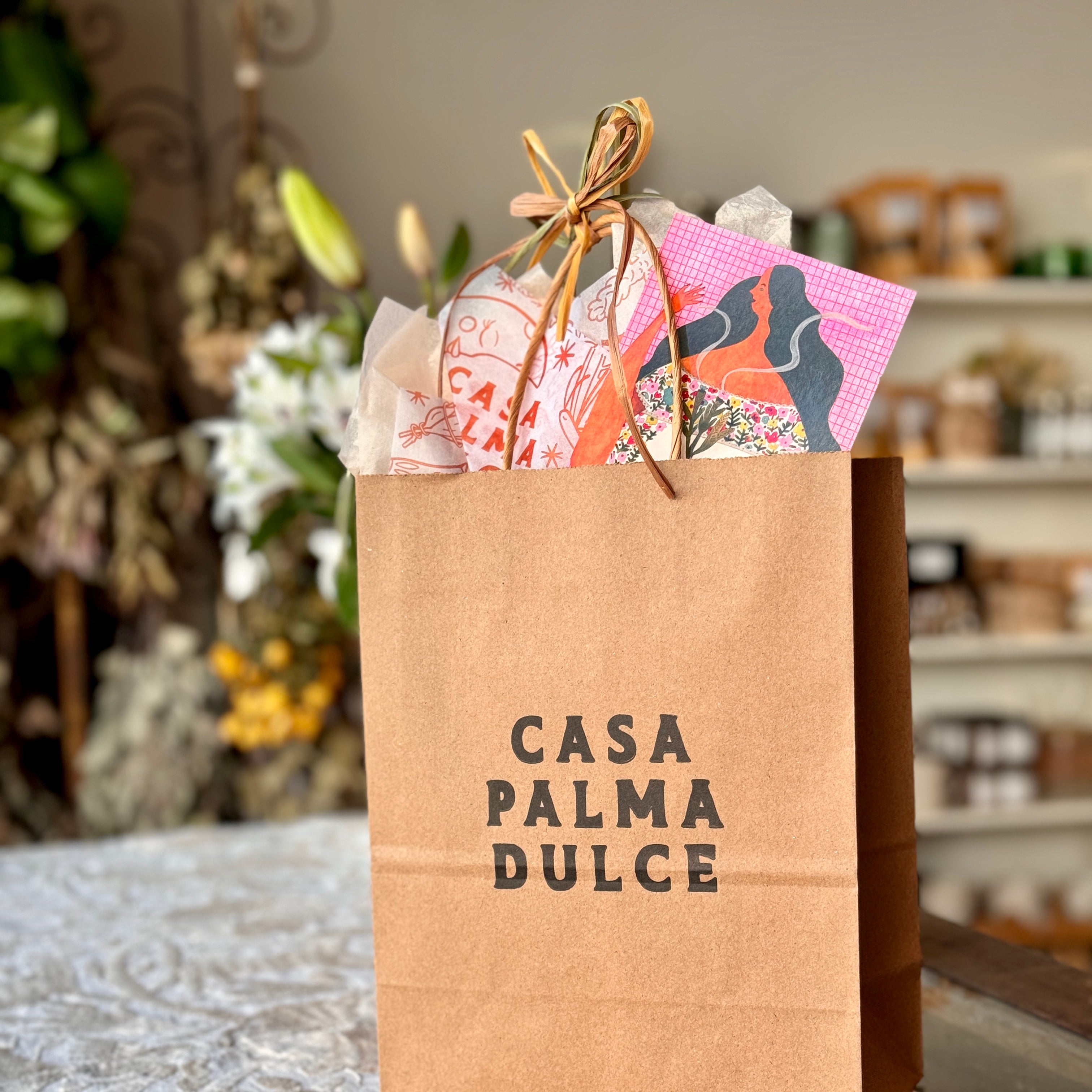 Photo of Casa Palma Dulce branded kraft shopping bag with branded tissue paper