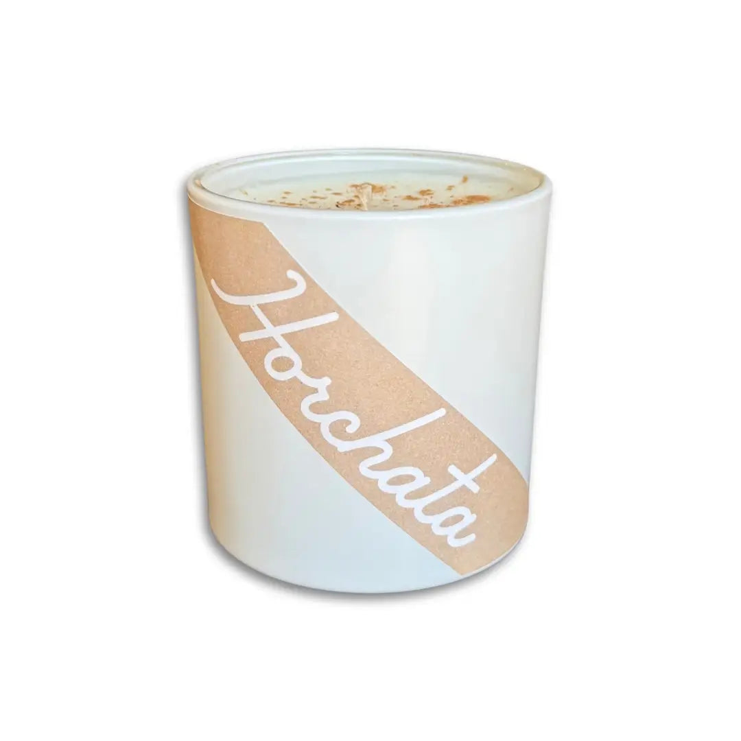 White horchata (cinnamon & vanilla) scented candle. Candle reads Horchata in cursive with light brown background and white lettering