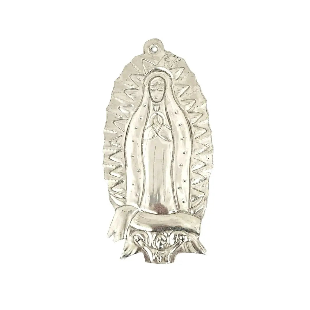 Handcrafted tin ornament featuring an embossed depiction of Our Lady of Guadalupe, surrounded by rays of light and intricate detailing, with a hole for easy hanging.