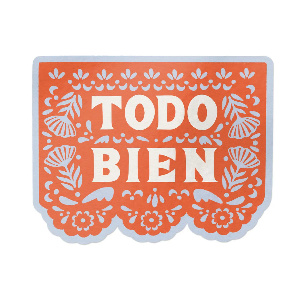 A die-cut sticker inspired by papel picado, featuring the phrase “TODO BIEN” in bold white letters on an orange background with floral and decorative cutout-style designs, outlined in pale blue.
