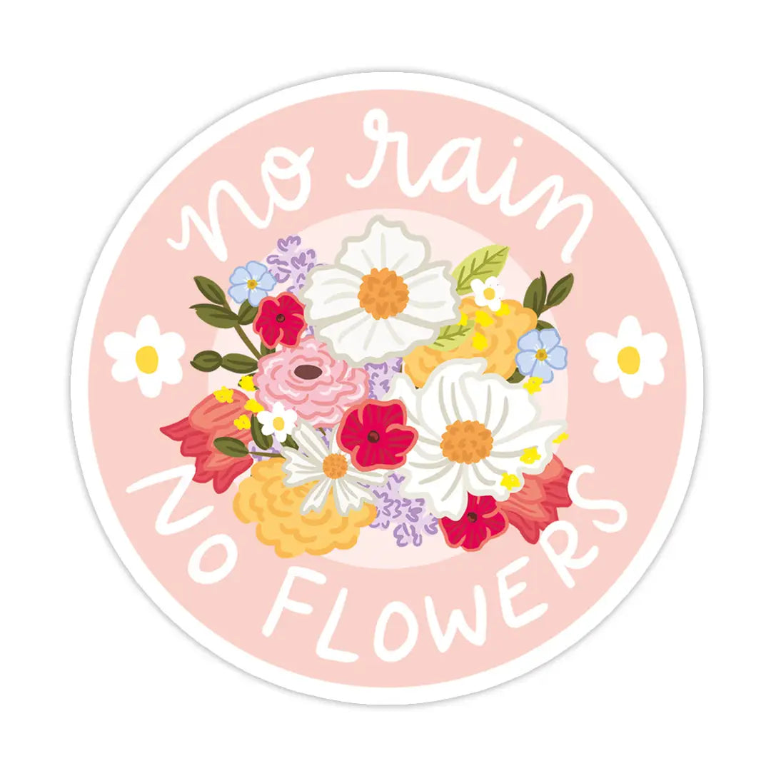 A round blush pink sticker with a colorful wildflower bouquet at the center and the text "No Rain No Flowers" in white cursive lettering.