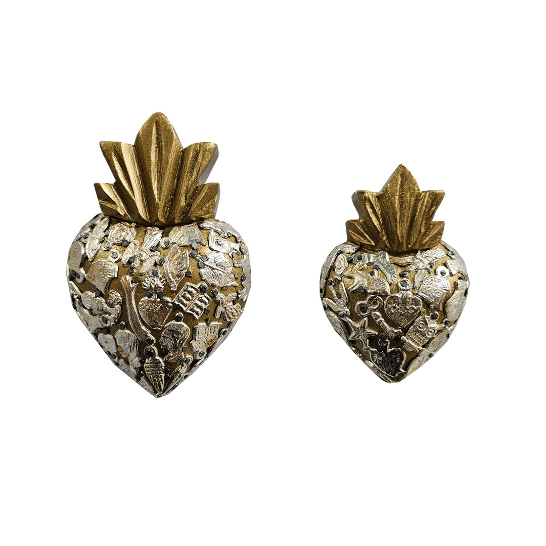 a set of gold milagro hearts, one larger than the other,  with various styles of milagro charms