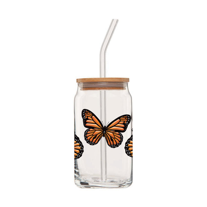 Clear can glass with an embossed wrap around design featuring four monarch butterflies & wooden lid and glass straw.